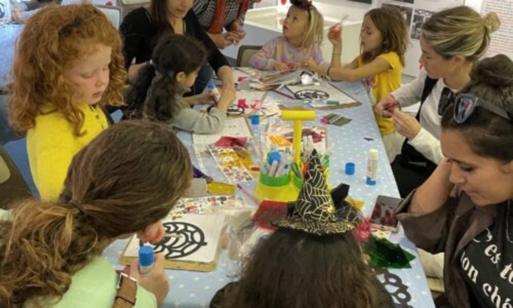 <Families doing a craft activity at a workshop